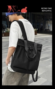Détail d'un sac cabas polyvalent en nylon noir montrant le tissu texturé et les boucles