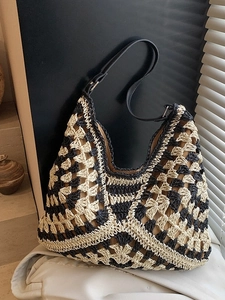 Woven beach tote bag in black and beige geometric pattern with adjustable leather strap