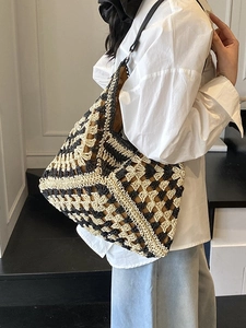 Chic woven beach tote bag with black and beige geometric patterns for summer vacations