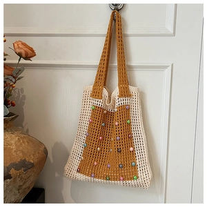 Detail of hand-woven hollow shoulder bag with colorful beads and contrast color design