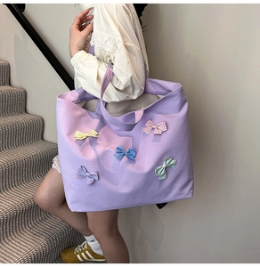Detailed view of purple checkered tote bag featuring five colorful polka dot bows