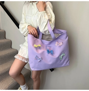Detail view of purple plaid canvas tote bag with colorful polka dot bow decorations
