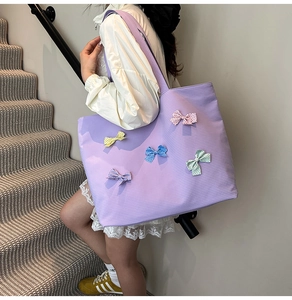 Detail of lavender canvas tote bag with colorful bows and micro-checkered texture