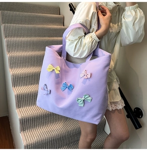 Detail view of purple checkered tote bag featuring five colorful polka dot bows