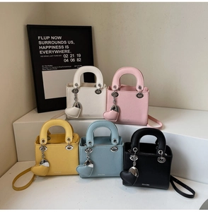 Detailed macro of textured leather mini bags in various colors with heart charms