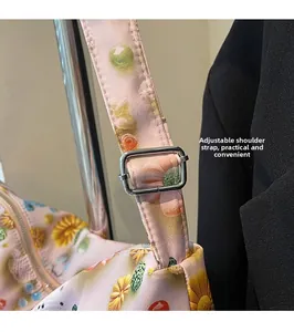 Detail of adjustable silver buckle on pink floral shoulder strap for leisure tote bags