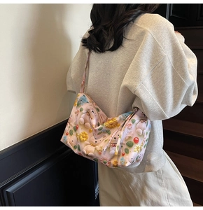 Rear view of model wearing a light pink casual tote bag with 3D cartoon bear patterns