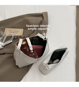 Detail of minimalist white bucket bag set with inner pouch showing large storage capacity