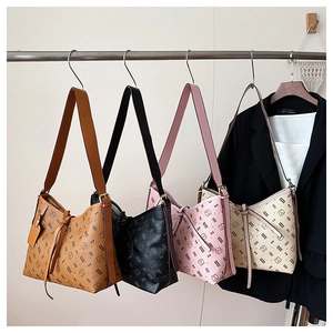 Detail view of retro leather tote bags in four colors with bear pattern and lettering