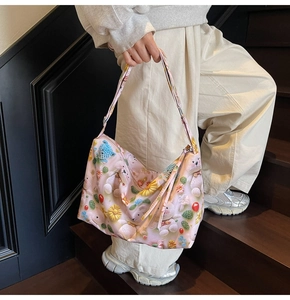 Detail of pink shoulder bag with 3D knit style cartoon bears and sunflower patterns
