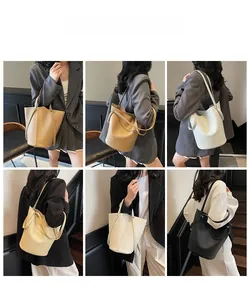 Litchi pattern leather bucket bag shown in multiple colors on model with drawstring detail