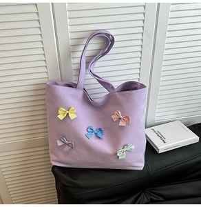 Detail of lavender plaid tote bag featuring five colorful polka dot bows and woven texture