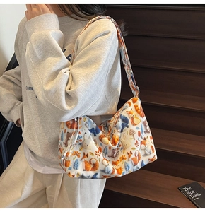 Lifestyle shot of white canvas shoulder bag with colorful cartoon forest animal prints