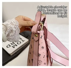 Pink shoulder bag detail showing the adjustable wide strap and gold metal buckle