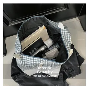 Detailed internal capacity of the blue houndstooth travel bag showing large storage space