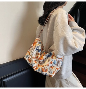 Detailed view of the wide shoulder strap featuring colorful forest animal patterns