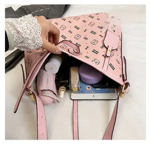 Top view of pink leather shoulder bag showing spacious interior with tablet and umbrella