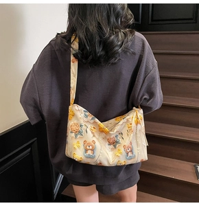 Detail of embroidered tote bag featuring cute yellow flowers and bear patterns