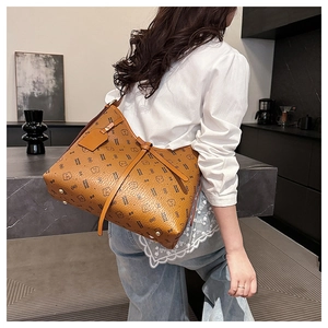 Detail of brown faux leather tote with cartoon bear prints and golden bottom rivets