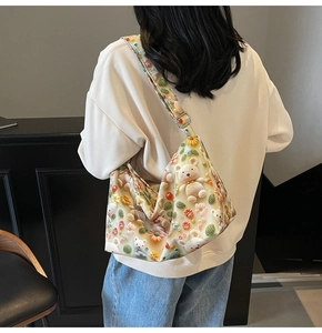 Detail of canvas tote bag with 3D cute bear and floral embroidery on wide strap