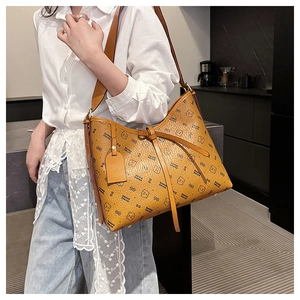 Detail of vintage brown tote bag with bear pattern and textured leather material
