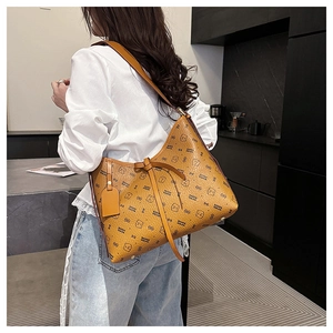 Detail of bear pattern printed leather shoulder bag with decorative bow and brand tag