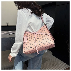 Side view of pink tote bag with bear print and textured finish on female model