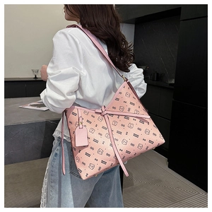 Detail of pink PU leather tote bag with cartoon bear pattern and long shoulder strap