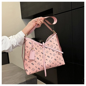 Detail of pink faux leather bag with bear pattern print and dual shoulder straps