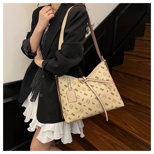 Detail of beige hobo bag with teddy bear pattern and adjustable shoulder strap style