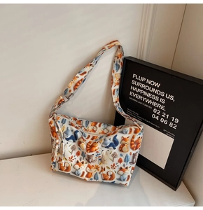 Detail of white canvas tote bag with colorful cartoon animal print and zipper closure