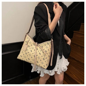 Detail of beige underarm bag with cartoon bear print and adjustable shoulder strap