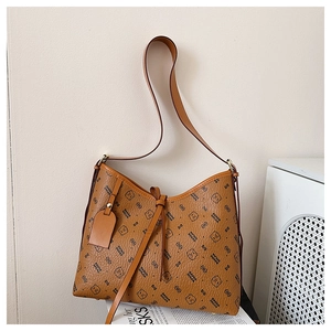 Detail of vintage brown shoulder bag showing textured faux leather and bear pattern print