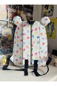 Detailed view of white cartoon backpack featuring colorful cat paw prints and cute 3D ears