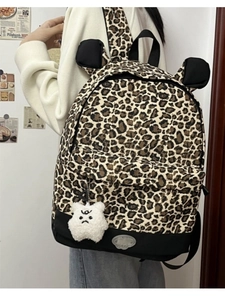 Detailed back view of leopard print backpack with bear ears and fluffy monster charm