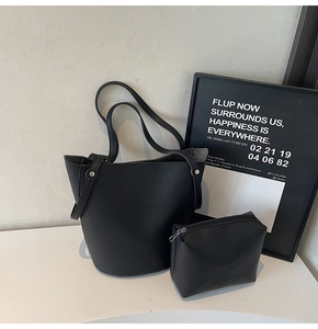 Detail of black lychee grain tote set featuring hand-stitched seams and matching pouch