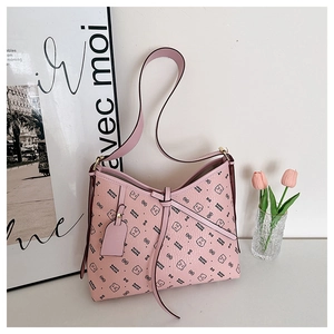 Close-up of pink hobo bag with teddy bear pattern and decorative lacing detail