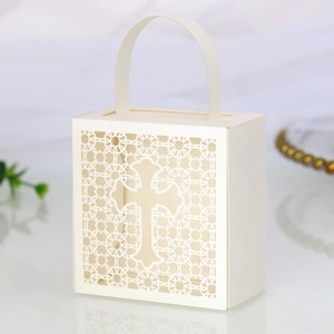 Detailed macro view of laser-cut cross pattern on white pearlescent paper wedding favor box