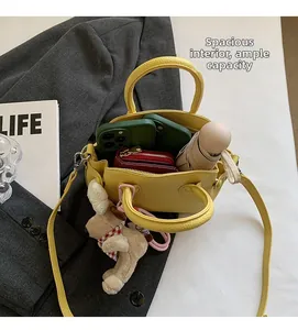 Interior view of yellow leather shell bag showing spacious storage for daily essentials