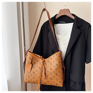 Detailed close-up of brown vintage shoulder bag with luxury brand logo print on a hanger