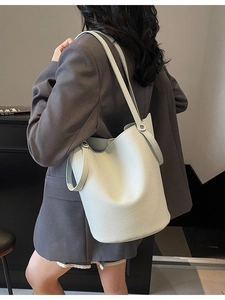 Light mint minimalist bucket bag in lychee texture leather with crossbody shoulder strap