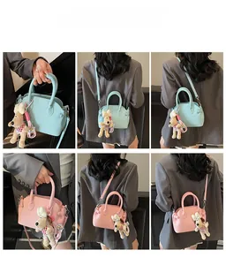 Detail shots of lychee pattern shell bag in blue and pink with cute dog pendant