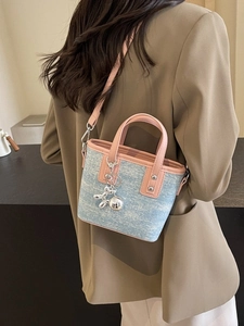 Pink and light blue contrast bucket bag with balloon dog charm and metal studs