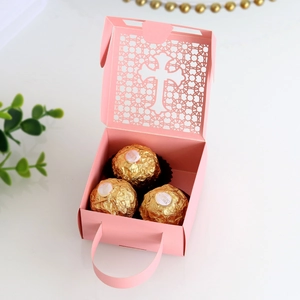 Detail of pink laser-cut cross hollow gift box with handle and floral pattern design