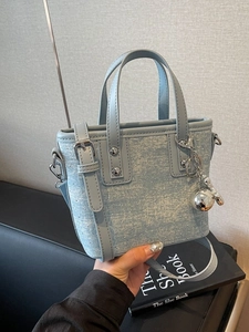 Chic light blue denim mini tote bag with silver glitter and metallic spherical charm