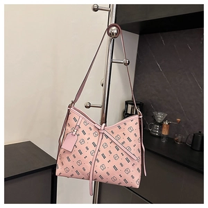 Detail of pink hobo bag with teddy bear prints and lychee leather texture hanging