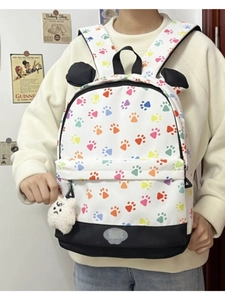 Detail view of cartoon panda ears and colorful claw print pattern on canvas backpack