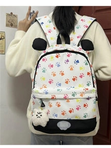 Detail of colorful animal footprint backpack with plush charm and decorative ears