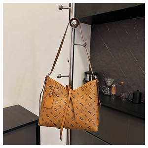 Detail of vintage brown shoulder bag with bear print and pebble texture leather