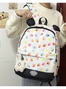 Detail of panda style leopard print backpack with cute ears and plush charm accessory